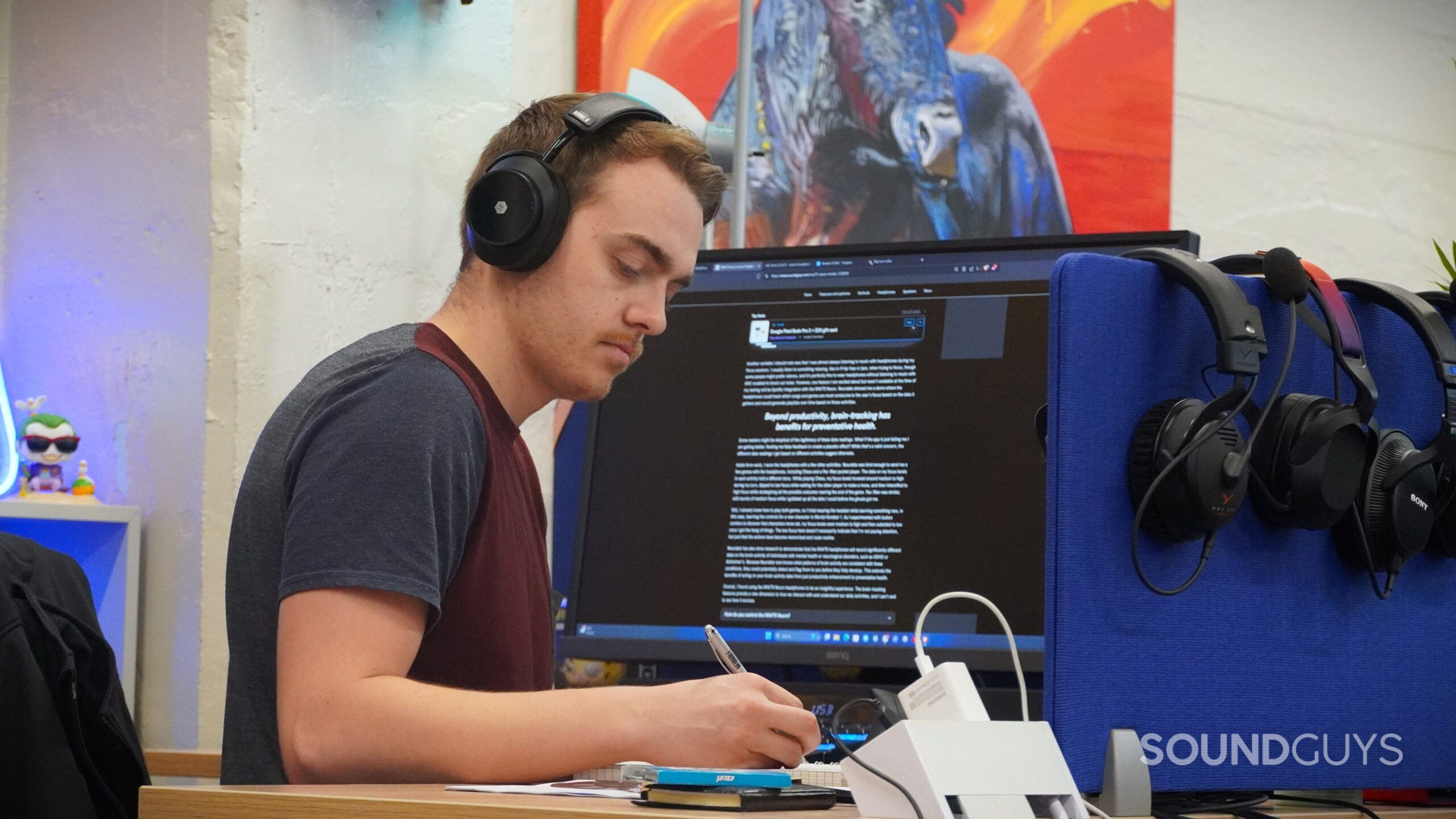 A man working at his desk wearing the MW75 Neuro headphones