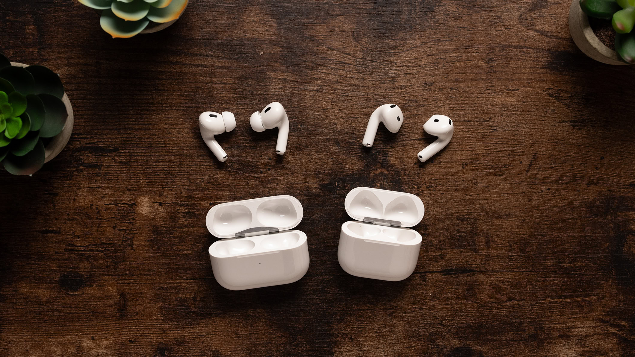 AirPods 4 with ANC next to the AirPods Pro 2 earbuds and charging case. 