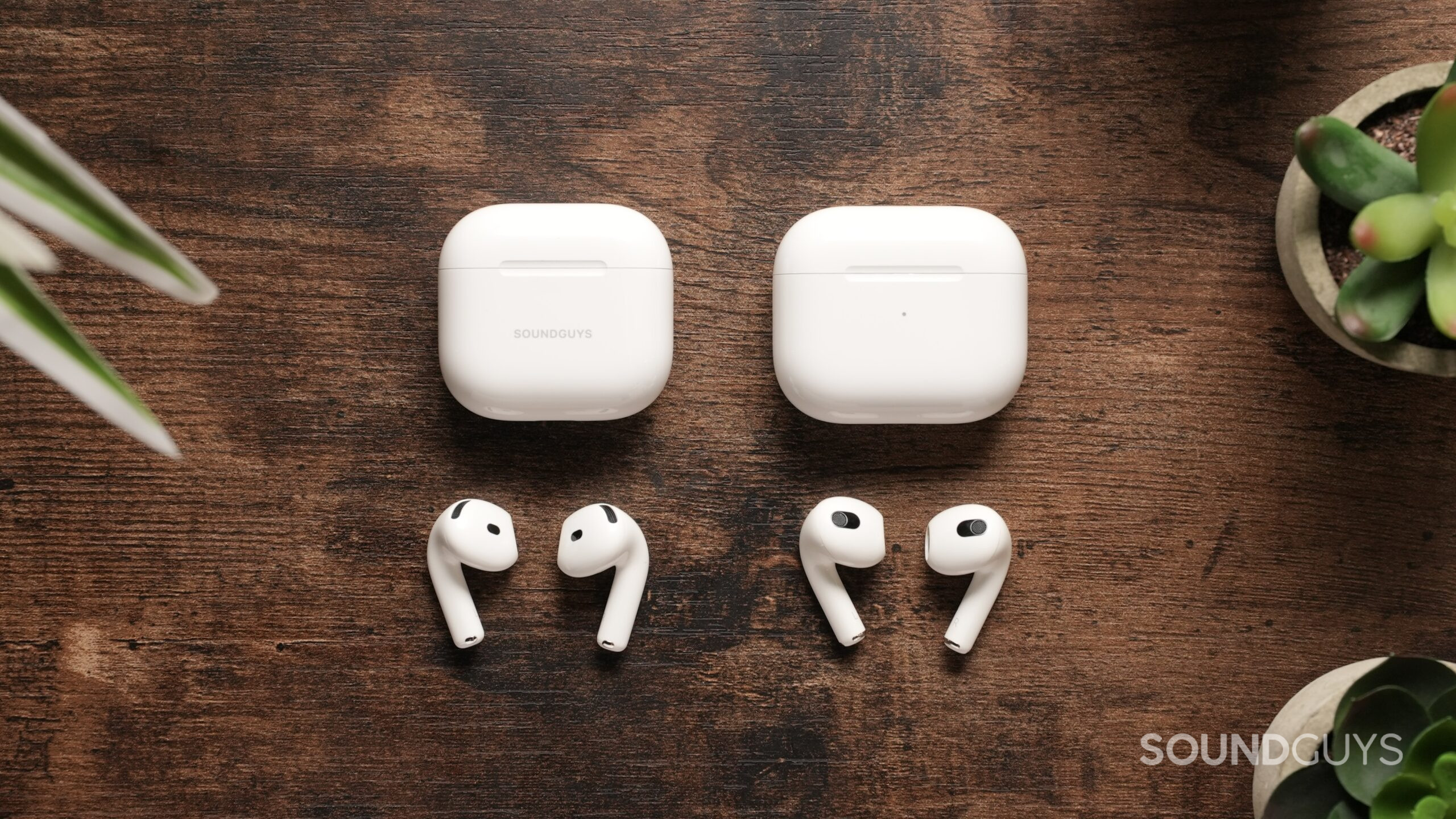 Top down view of the AirPods 4 next to the Airpods 3, out of their cases.