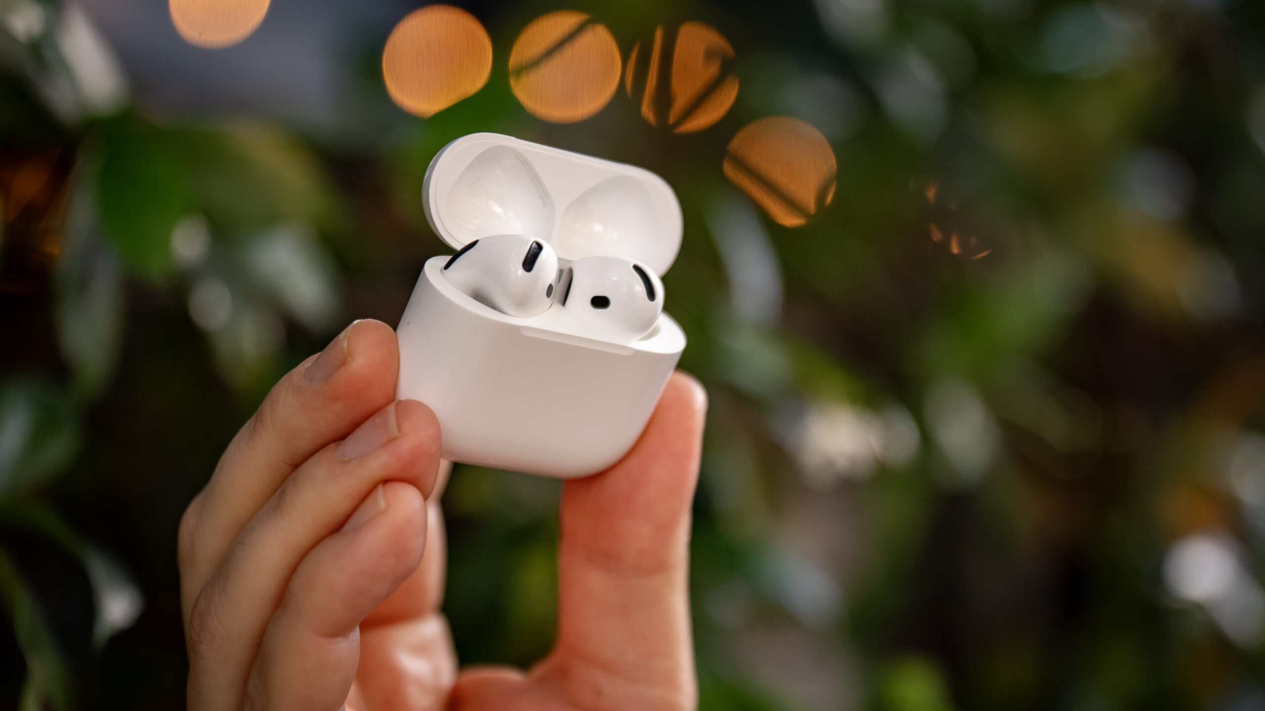 AirPods 4 in-hand