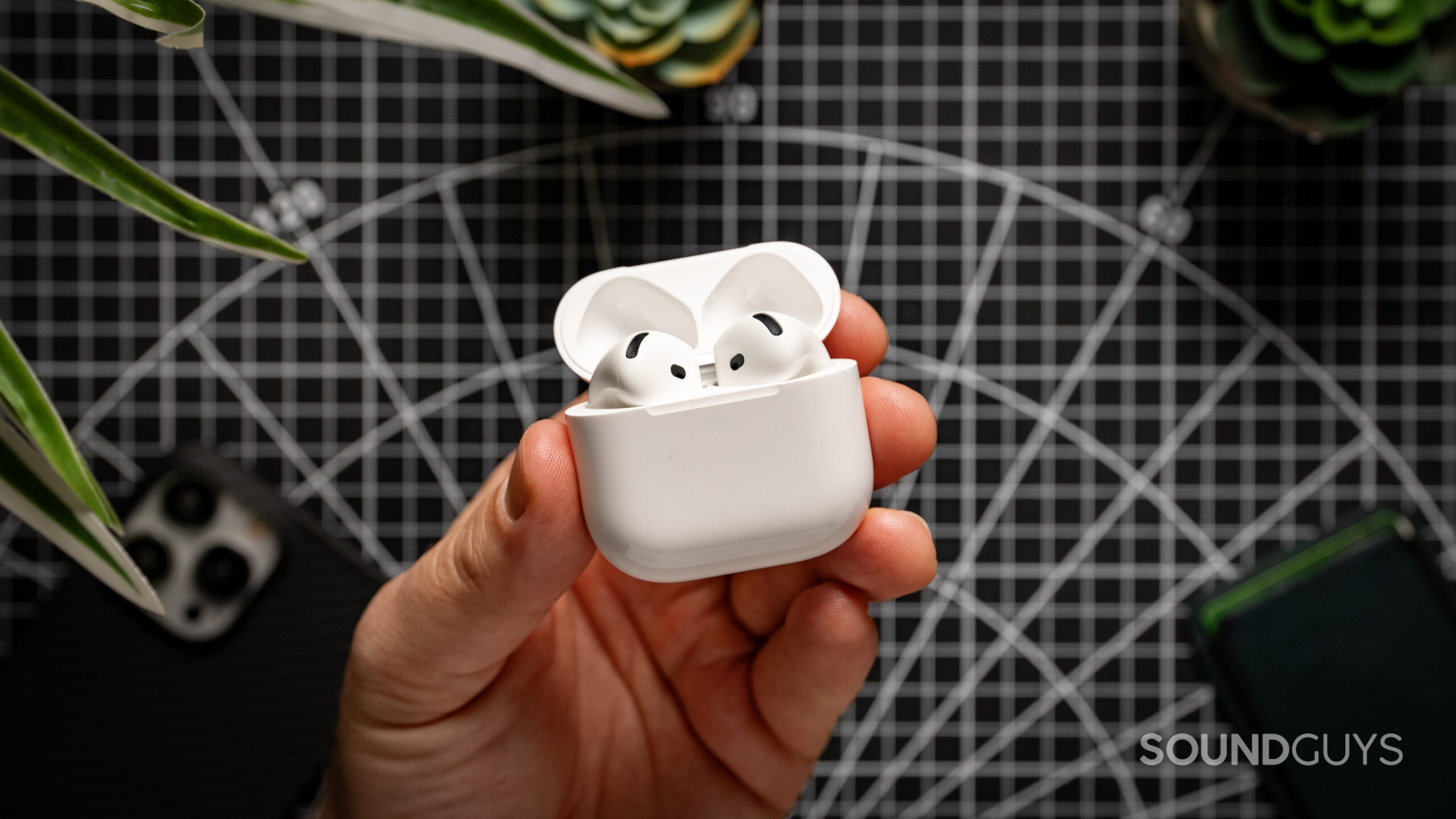 A hand holding the AirPods 4 case.