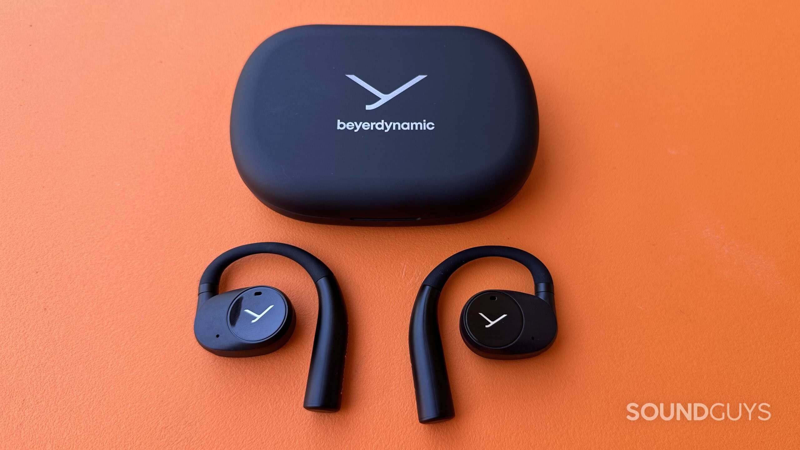 Top down photo of the VERIO 200 earbuds out of their case, with the charging case above.