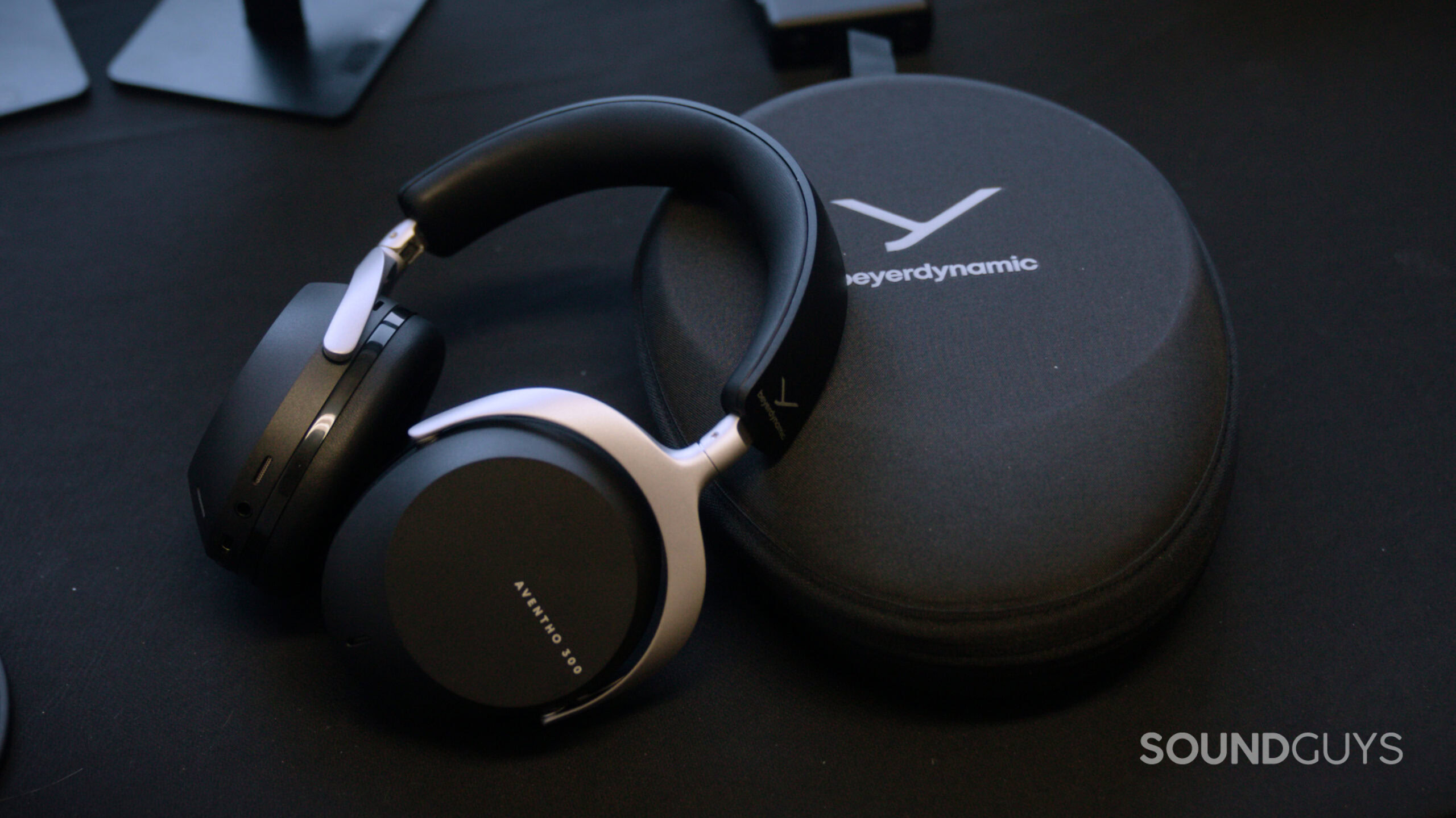 Beyerdynamic AVENTHO 300 headphones next to their carrying case.