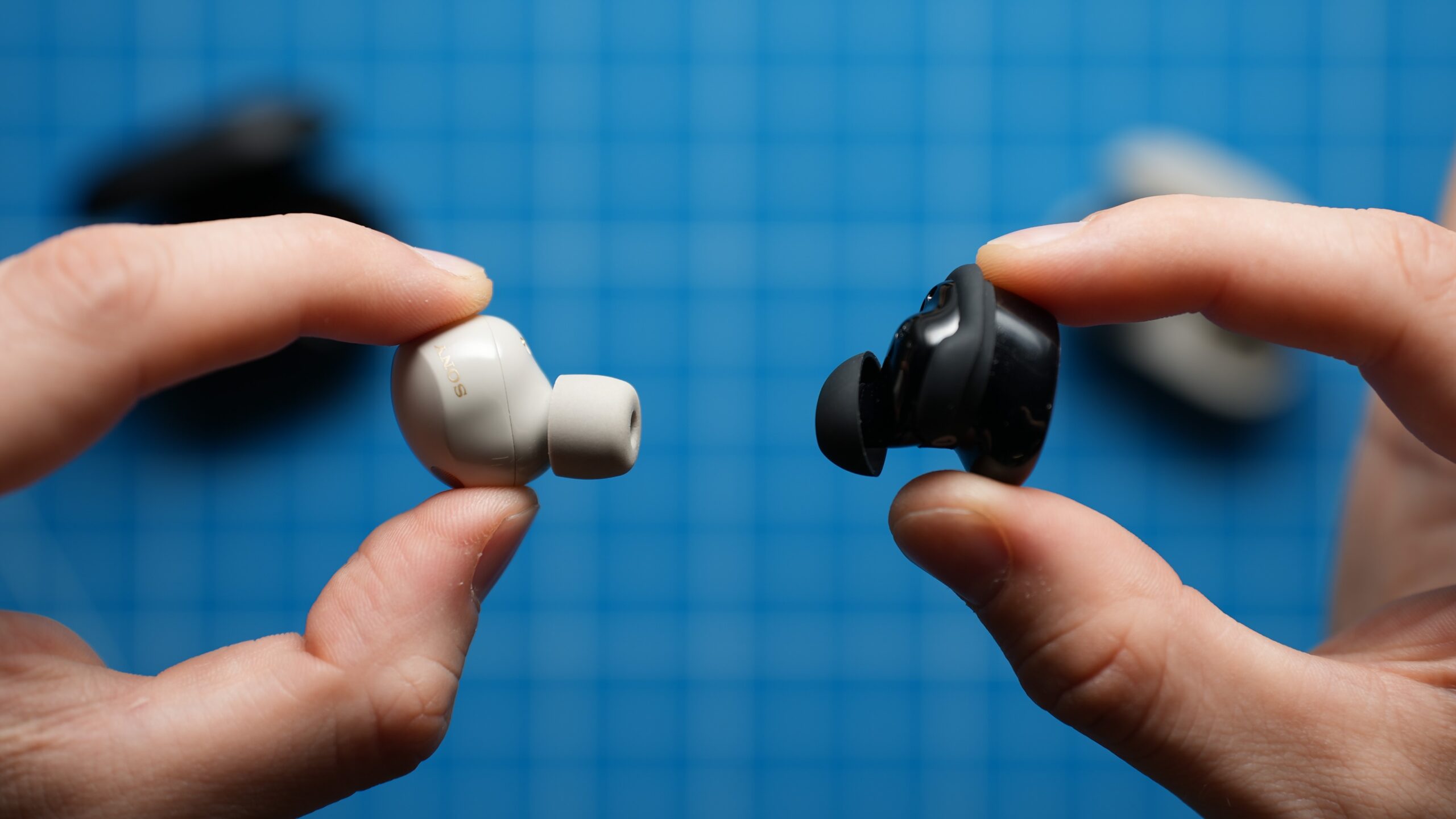 Bose QC vs Sony XM5 earbuds in hand