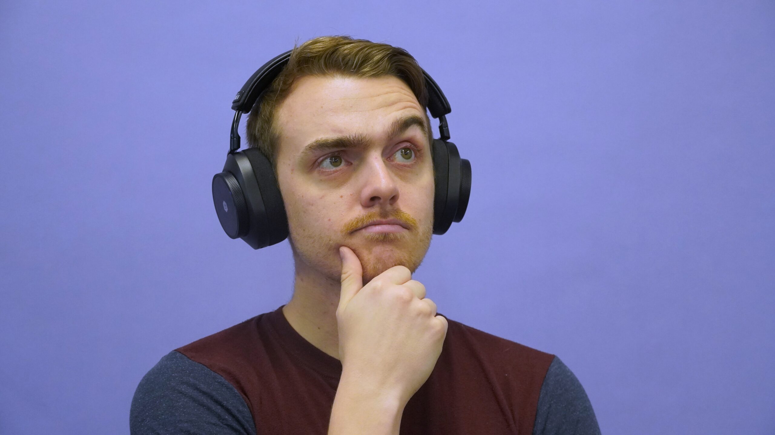 a man wearing headphones while thinking.