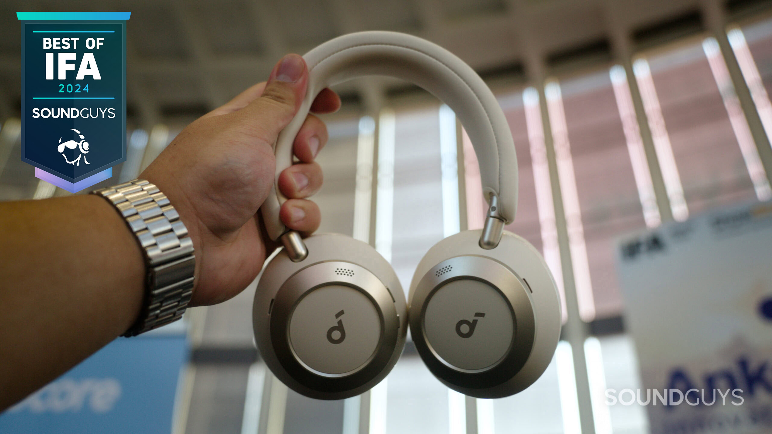 A hand holding the Anker Soundcore Space One Pro headphones. 