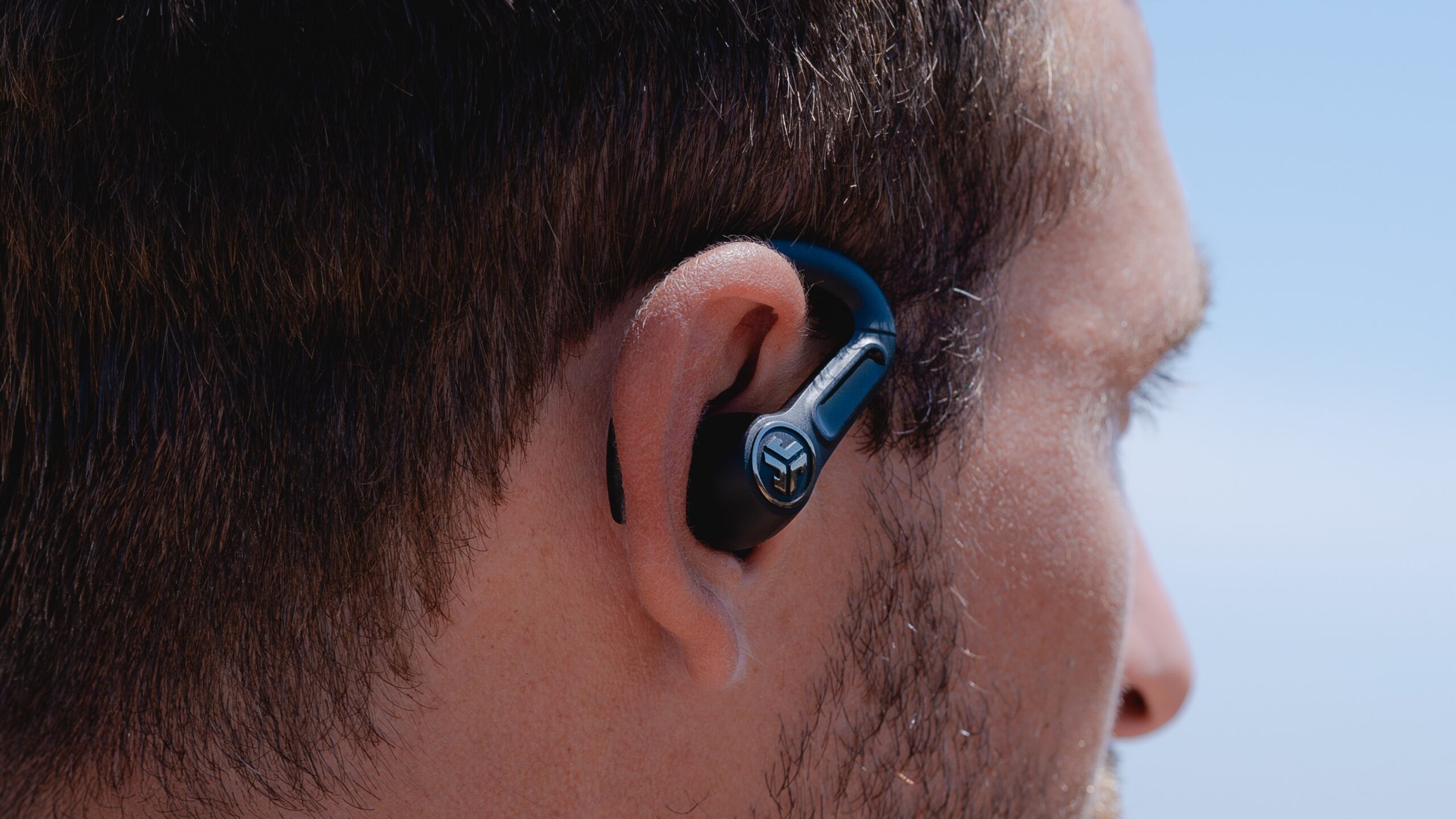 A man wearing the JLab Epic Sport 3 ANC in ear