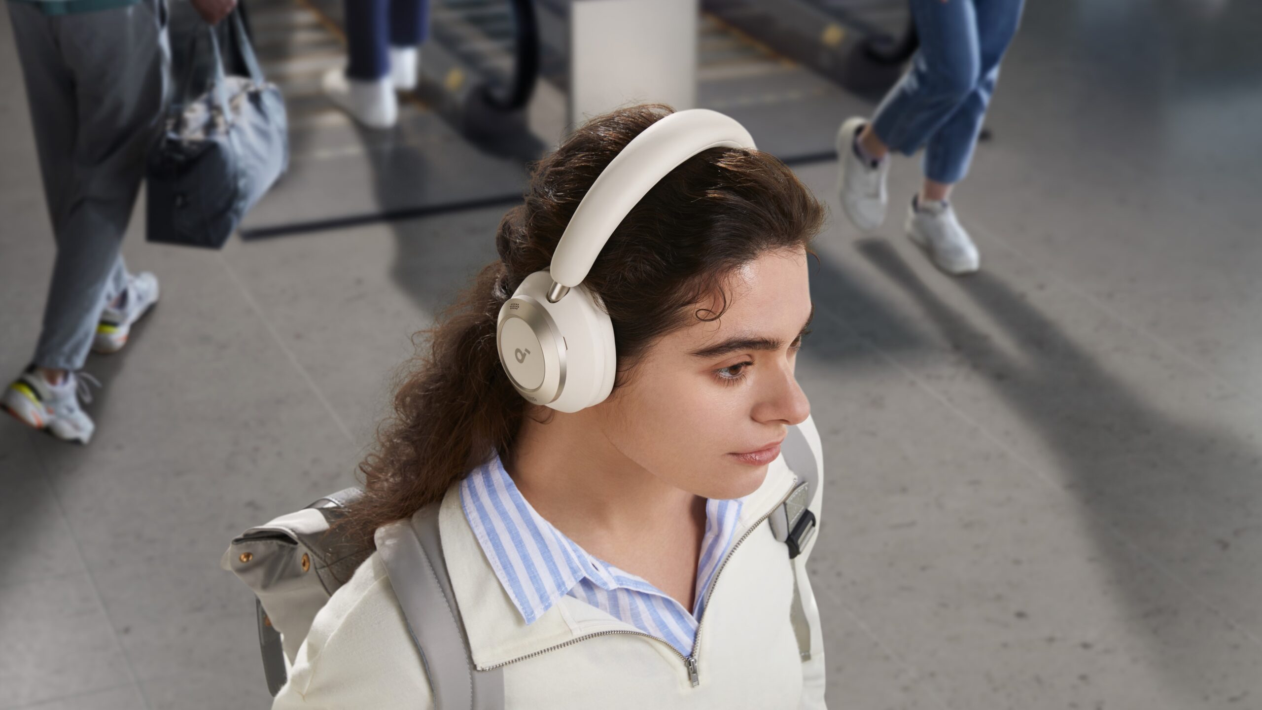 a woman wearing the anker soundcore space one pro headphones