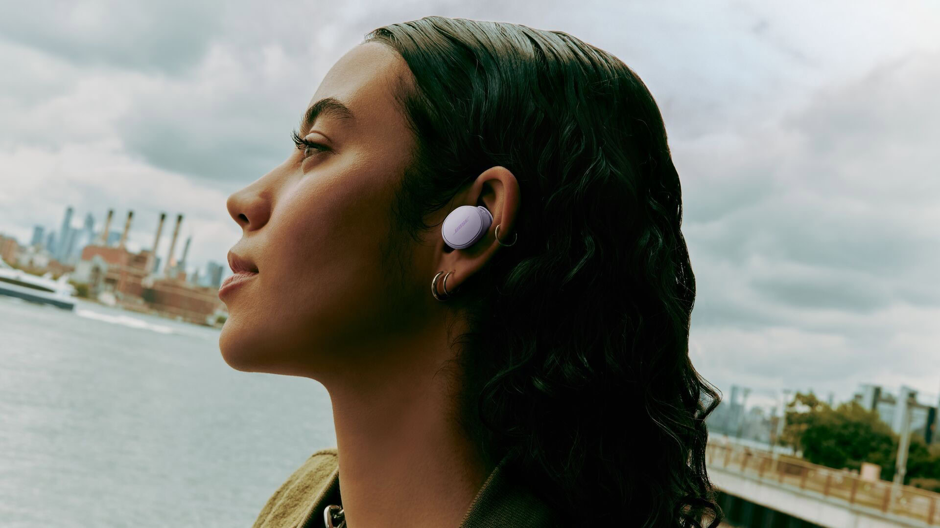 a girl wearing the bose quietcomfort earbuds