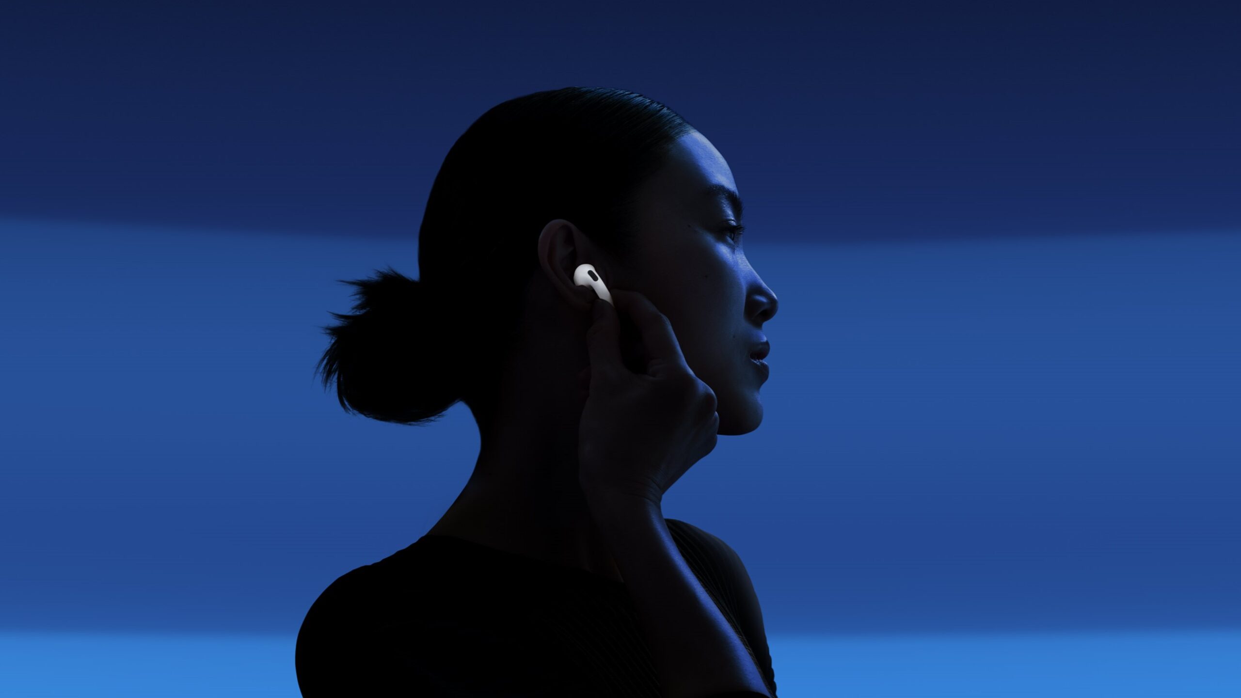 a woman wearing the apple airpods 4