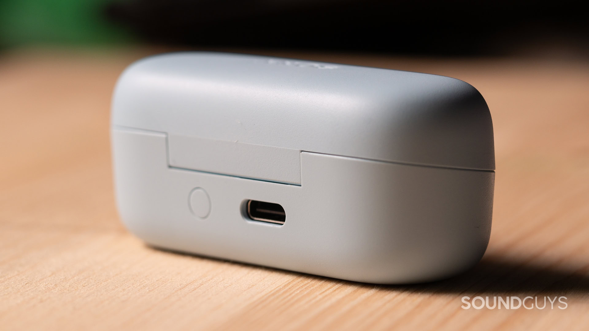 A photo of the Sony QF-C510's charging case, with USB-C port and pairing button.