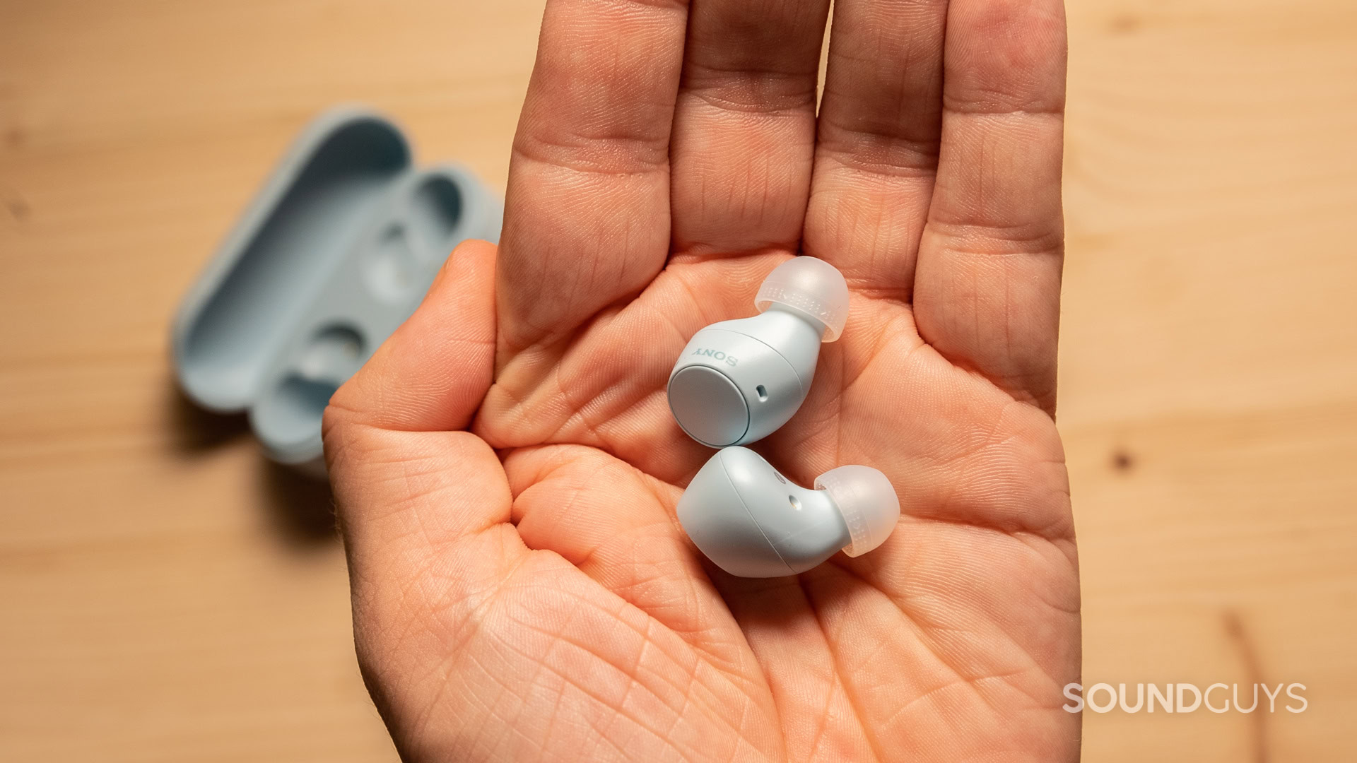 A photo of the Sony WF-C510's earbuds in a hand.