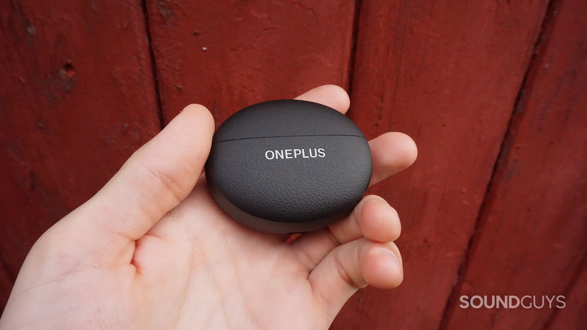 A photo of the OnePlus Buds Pro 3 charging case being held.