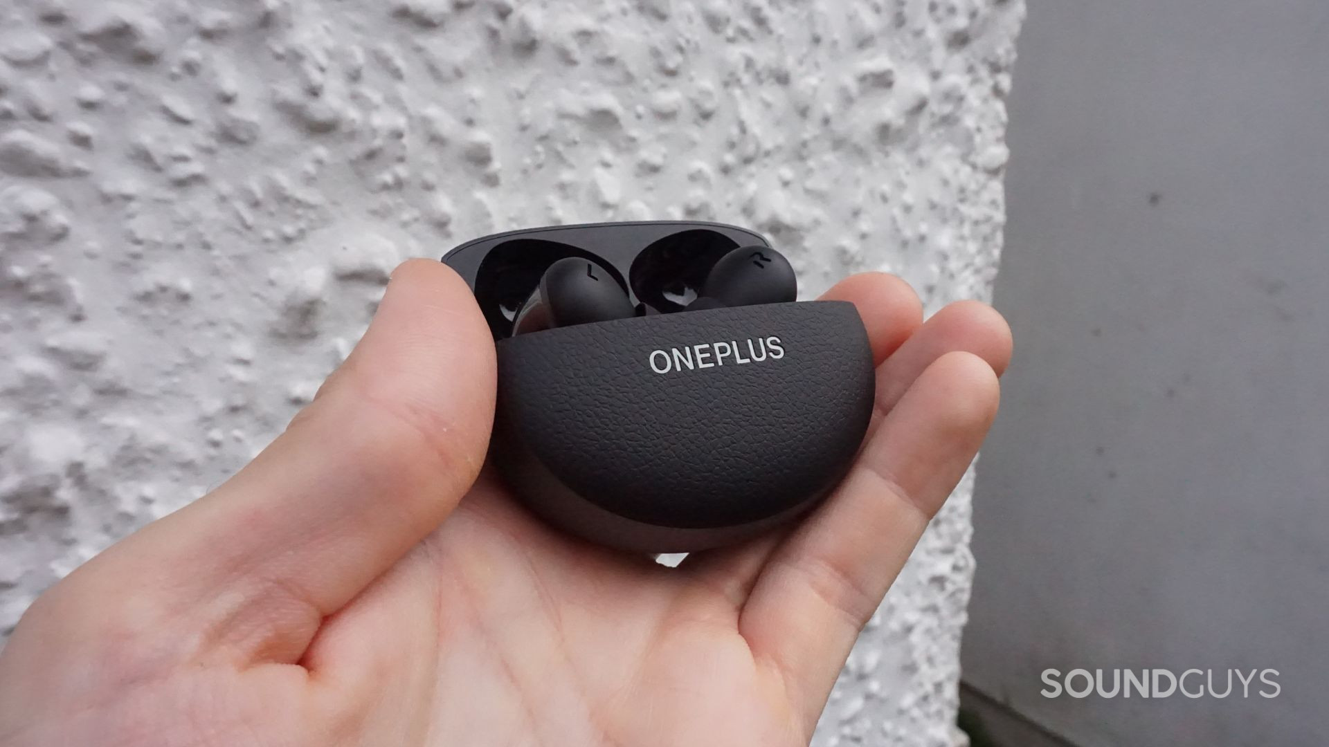 A photo of the OnePlus Buds Pro 3 earbuds in their charging case.