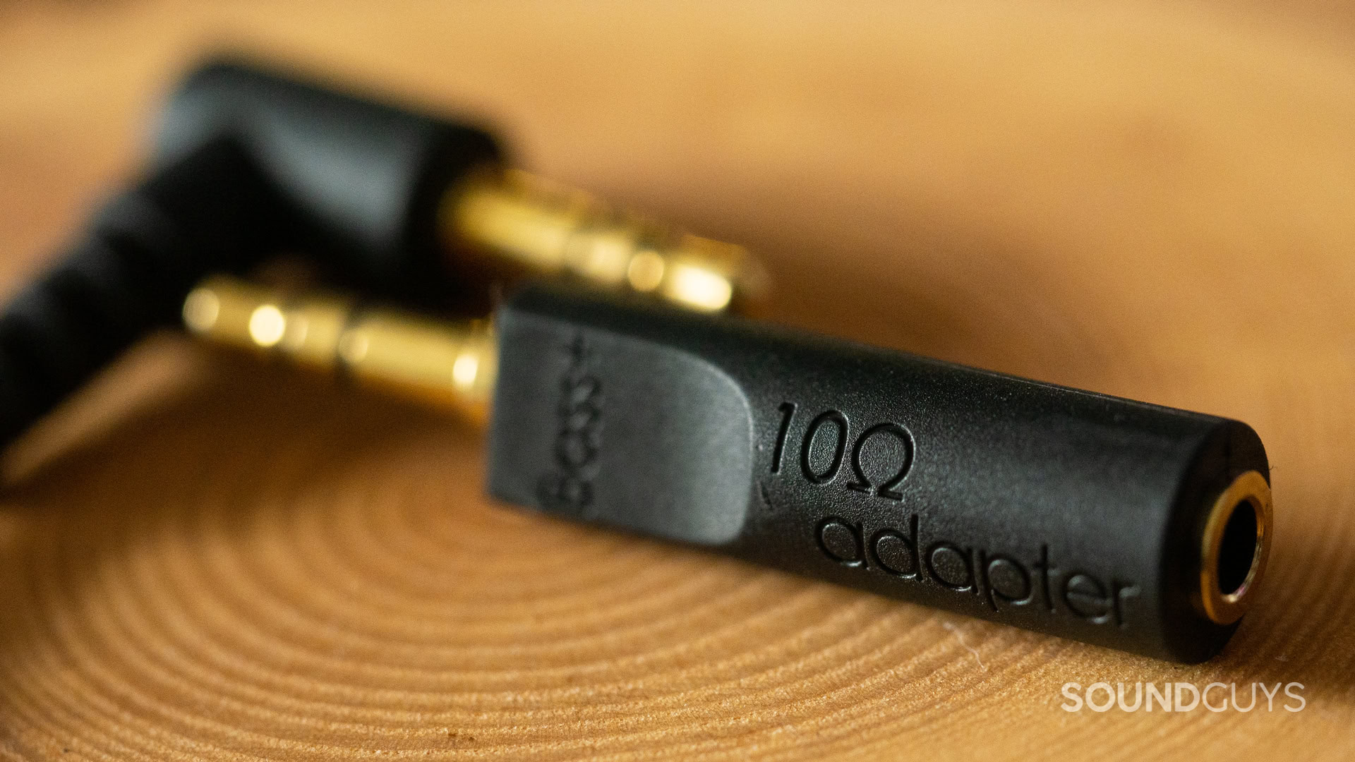 A photo of the TRS Plug and the 10Ω adapter included with the earbuds.