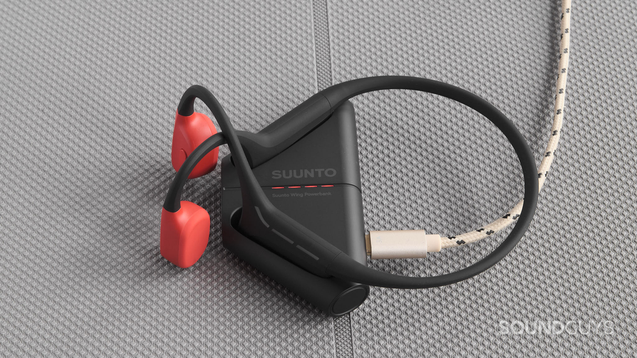 The Suunto Wing rest in the charging cradle.