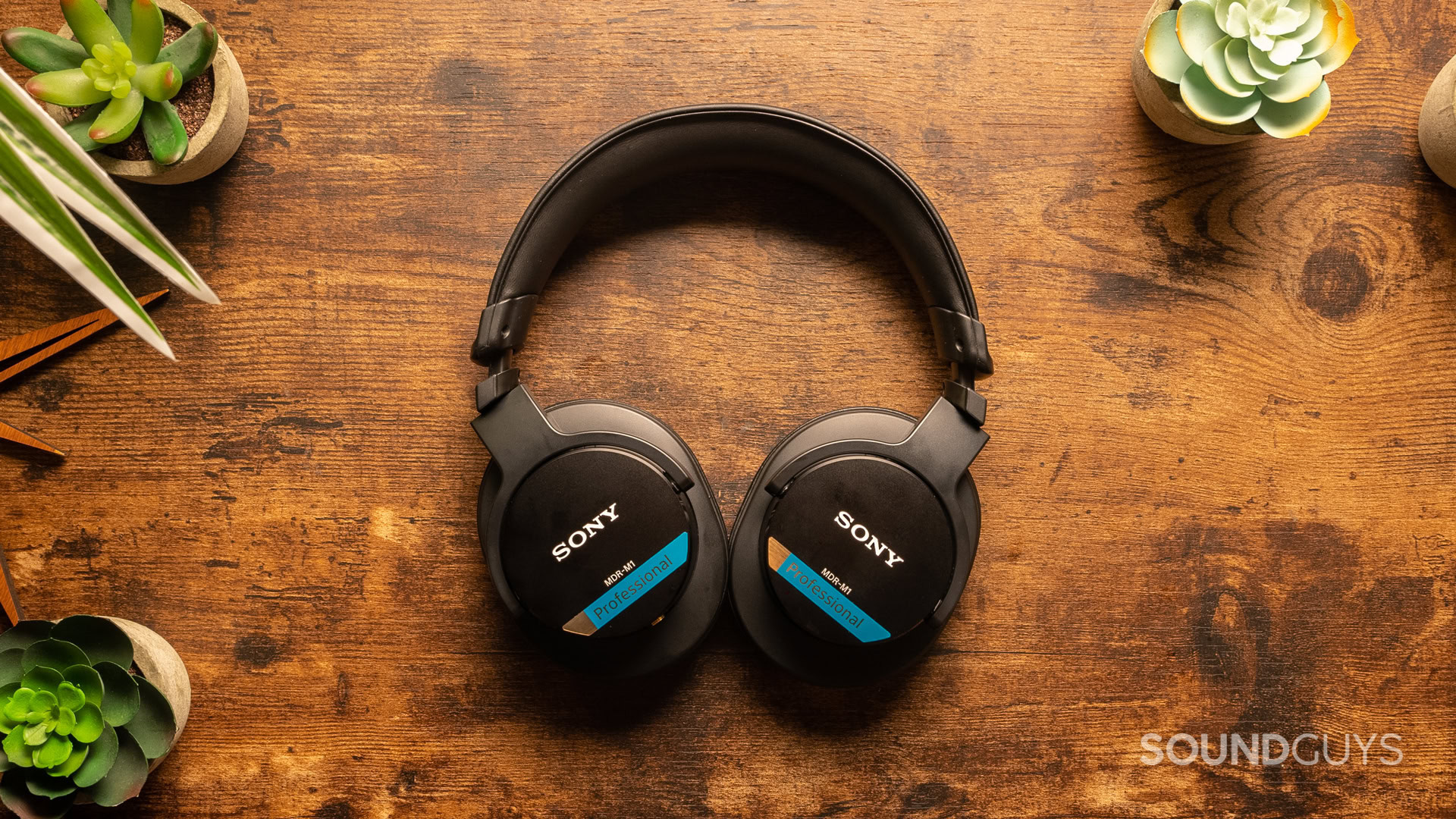 A photo of the Sony MDR-M1 on a wooden desk.