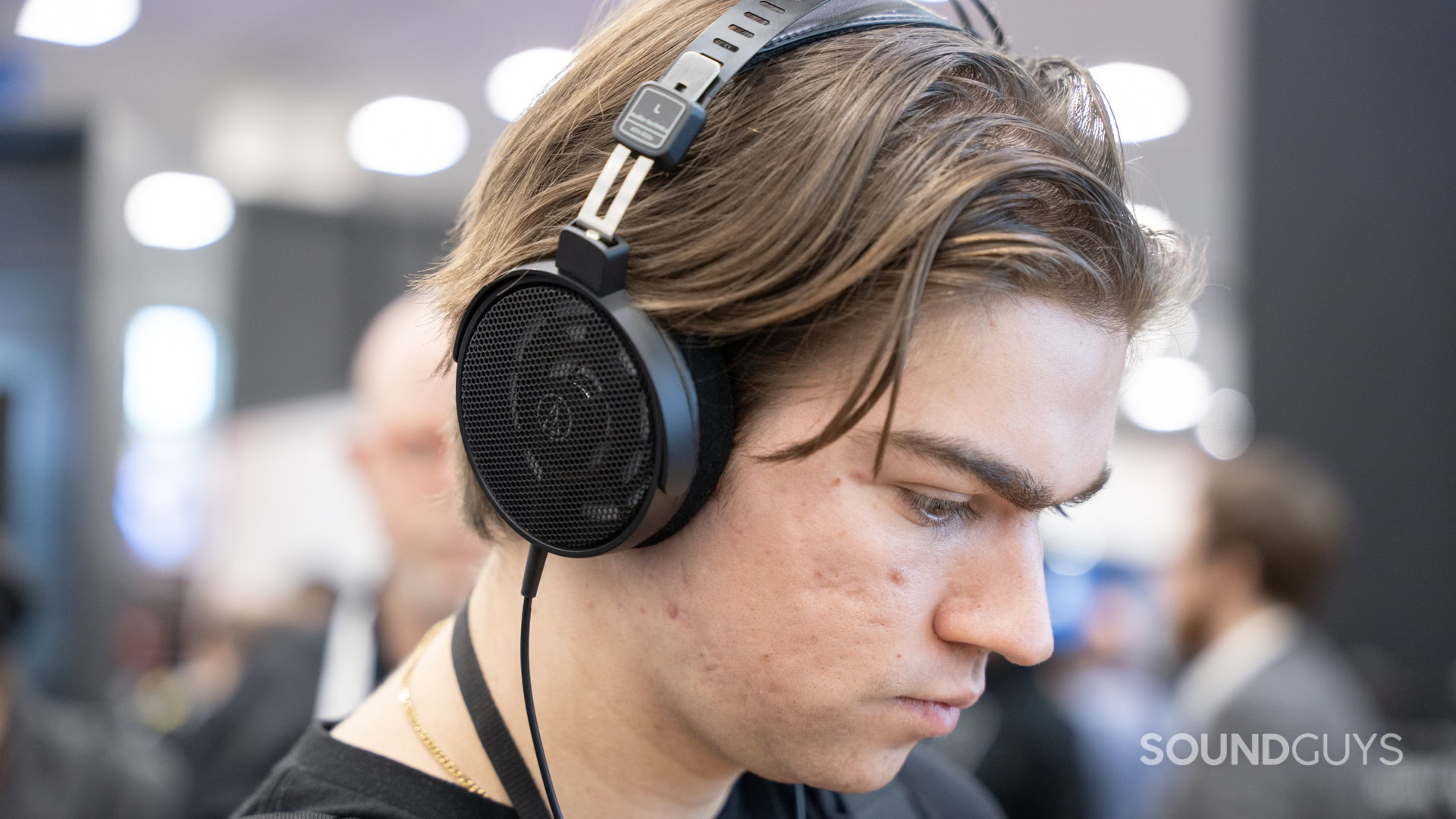 A man wearing the Audio-Technica ATH-R30x open back headphones.