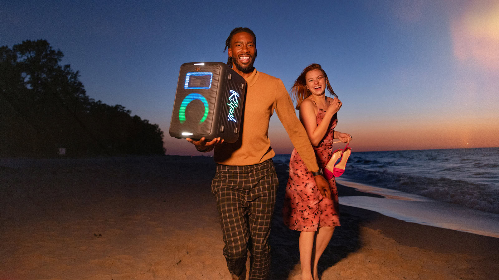 A man holding the Klipsch Vegas party speaker.