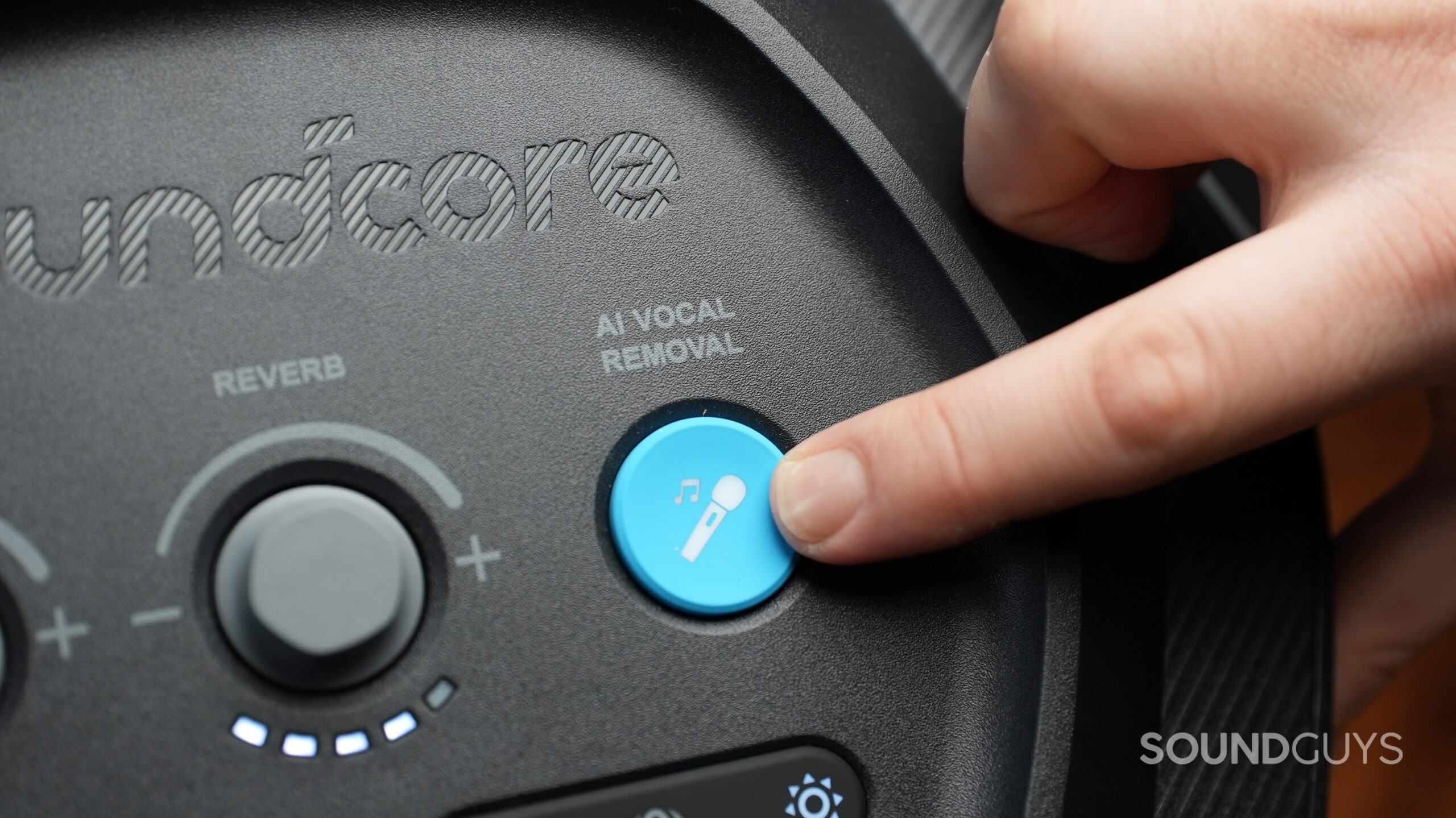 Close up photo of a finger pointing to the AI Vocal Removal button on the Rave 3S party speaker.