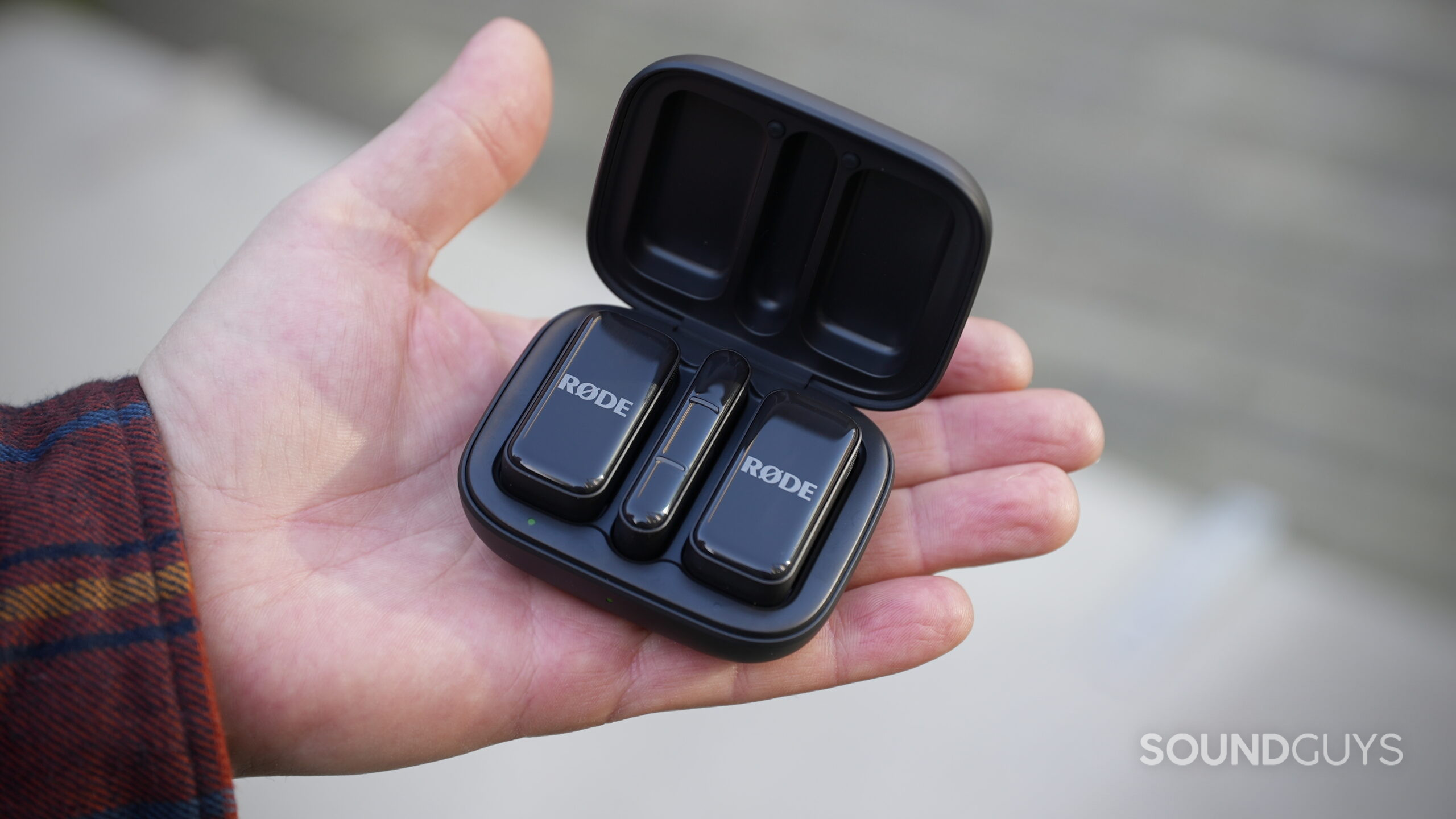 An open Rode Wireless Micro charging case in the palm of a hand.