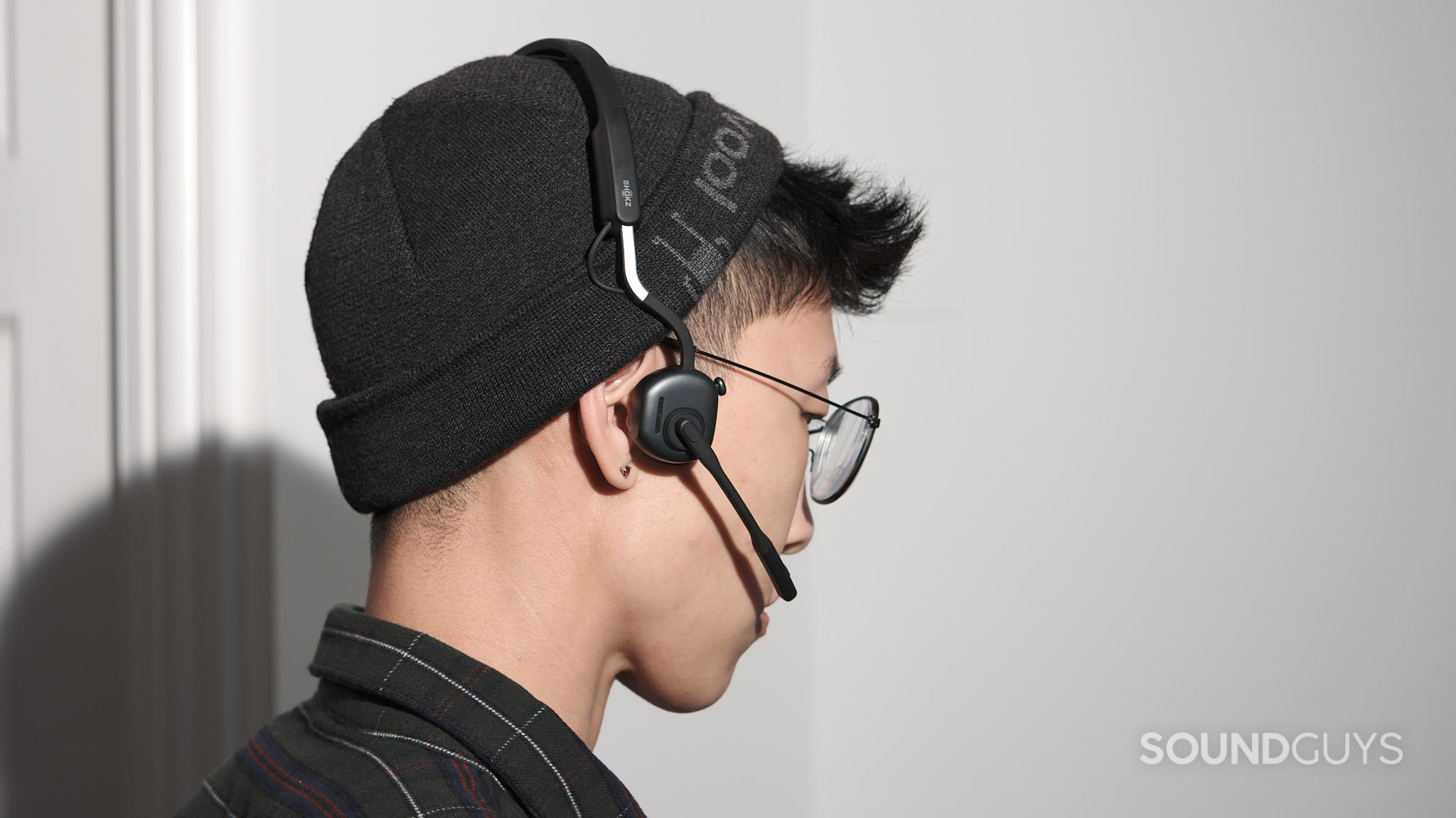 A person wears the Shokz OpenMeet UC.