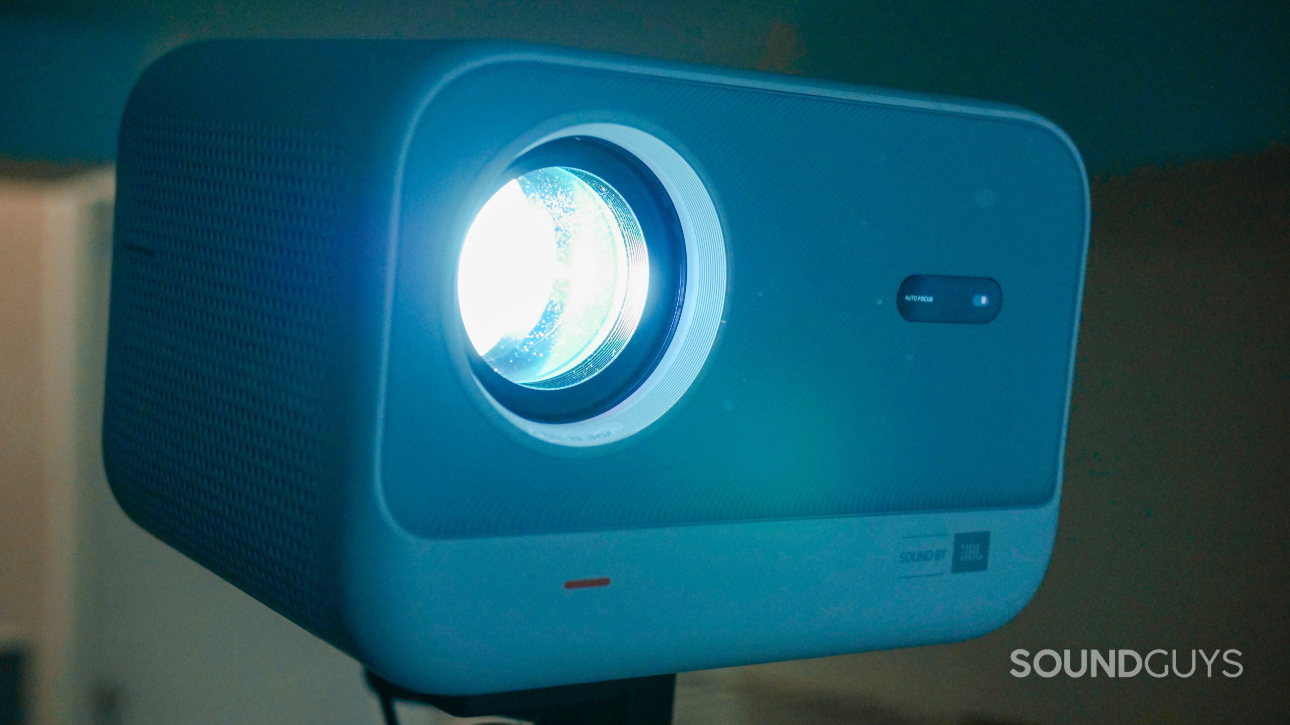 The Yaber L2s Projector turned on in a home theater with the lights off