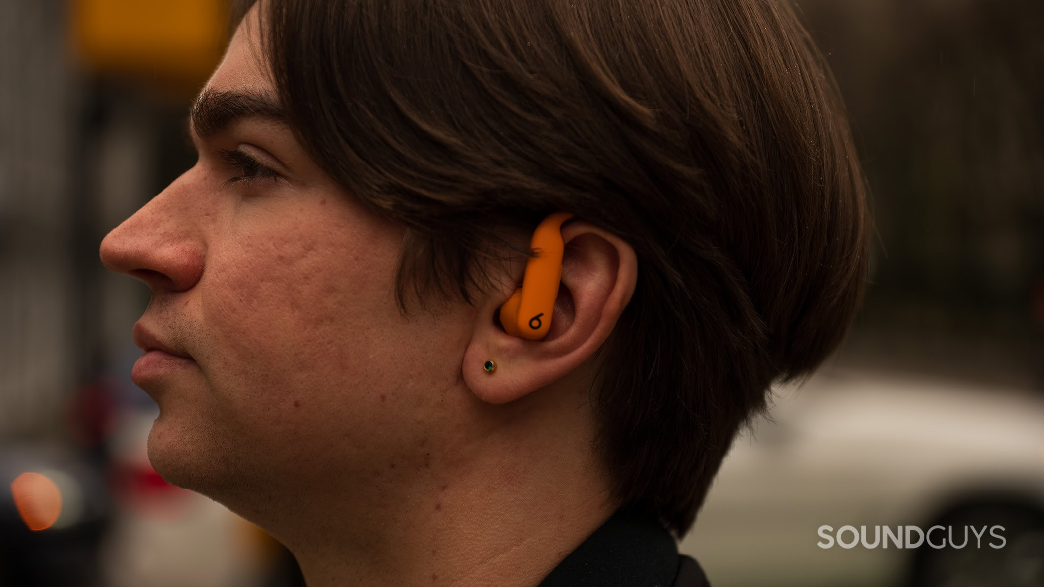 A man wearing the Powerbeats Pro 2 earbuds listening to music.