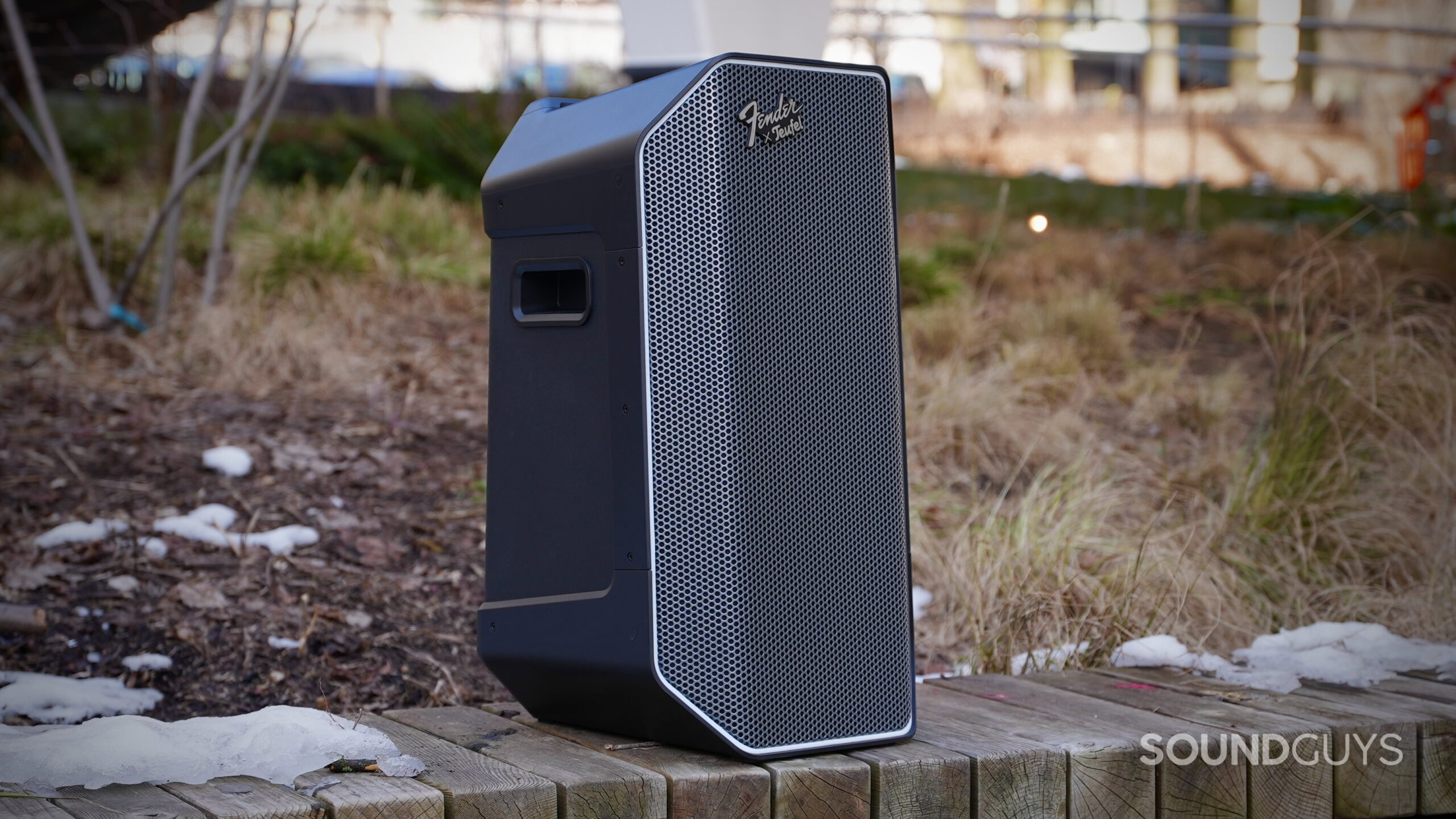 The Fender x Teufel ROCKSTER AIR 2 Portable Bluetooth Speaker placed on a wooden bench.