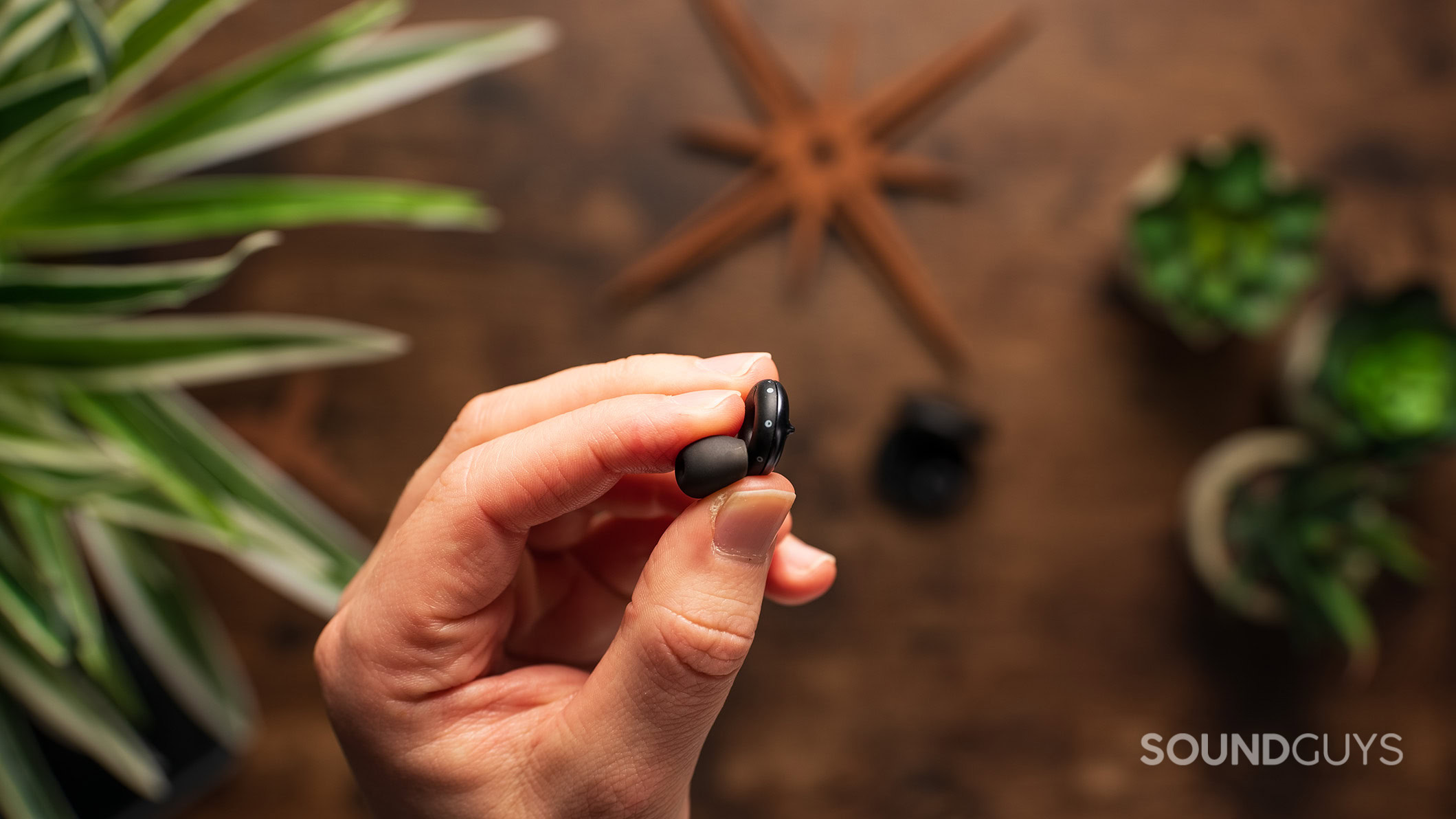 A hand holds the Loop Switch 2 earplug.