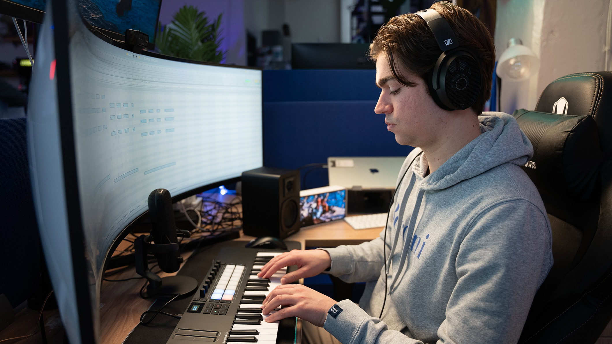 A man plays the Novation Launchkey Mini MK4 keyboard.