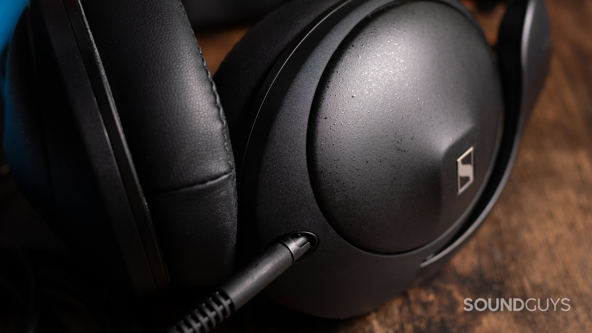 A close-up photo of the Sennheiser HD 620S' locking cable port on the left earcup.