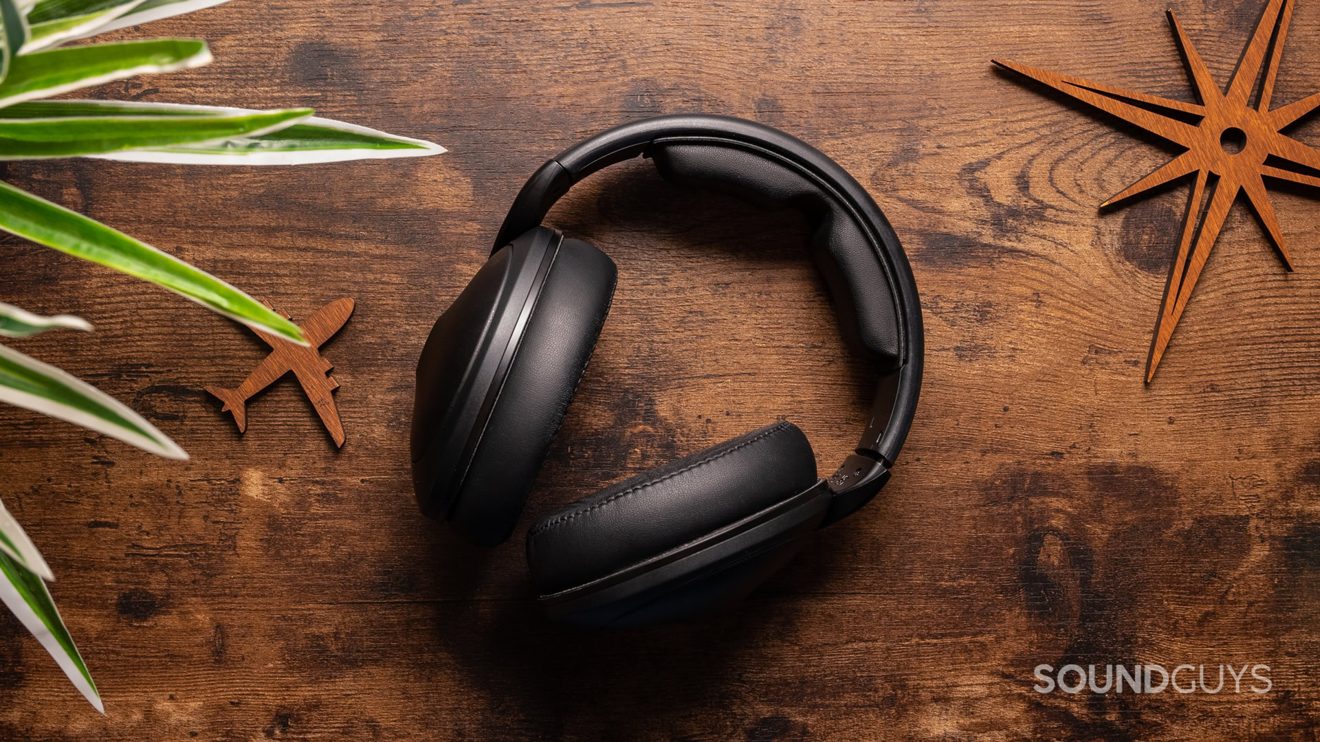 A photo of the Sennheiser HD 620S sitting atop a wooden desk.