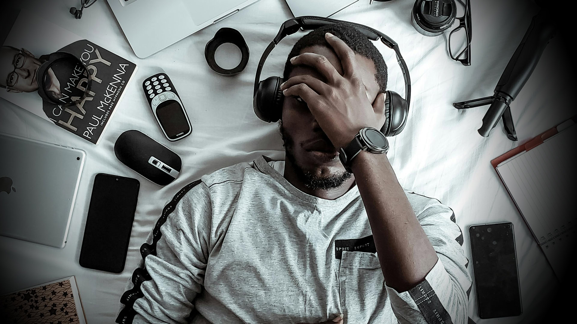 A photo of an exasperated man listening to headphones.